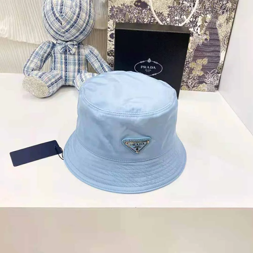 Prada Nylon Bucket Hat Decorated with the Triangle Logo for Women in Blue Prada Nylon Bucket Hat Decorated with the Triangle Logo for Women in Blue