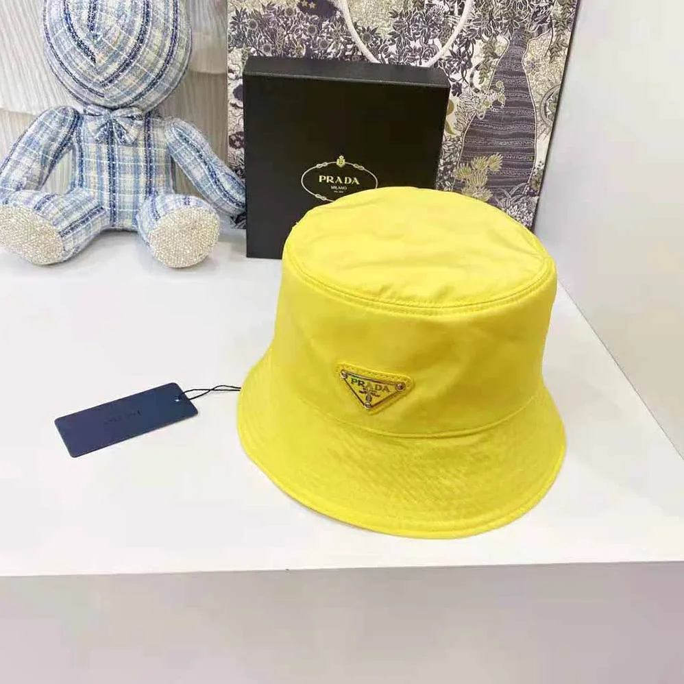 Prada Nylon Bucket Hat Decorated with the Triangle Logo for Women in Yellow
