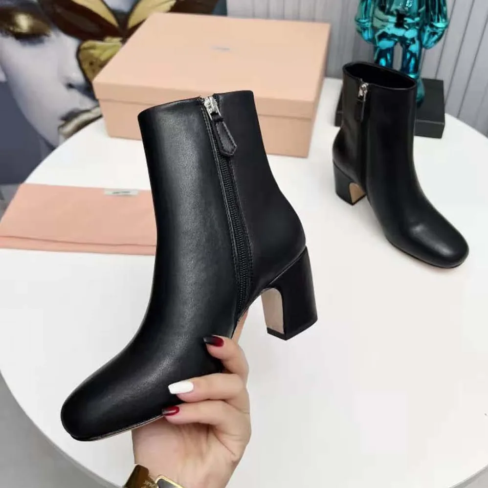 Miu Miu Leather Booties with Metal Lettering Logo for Women in Black