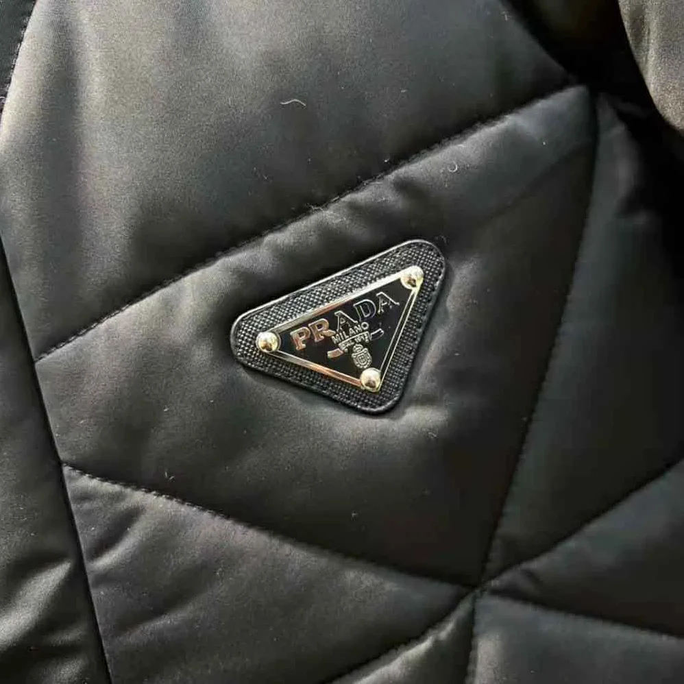 Prada Emblematic Triangle Quilted Re-Nylon Jacket for Women in Black Prada Emblematic Triangle Quilted Re-Nylon Jacket for Women in Black