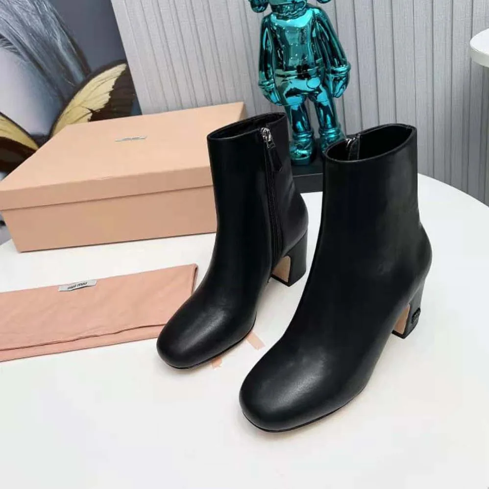 Miu Miu Leather Booties with Metal Lettering Logo for Women in Black