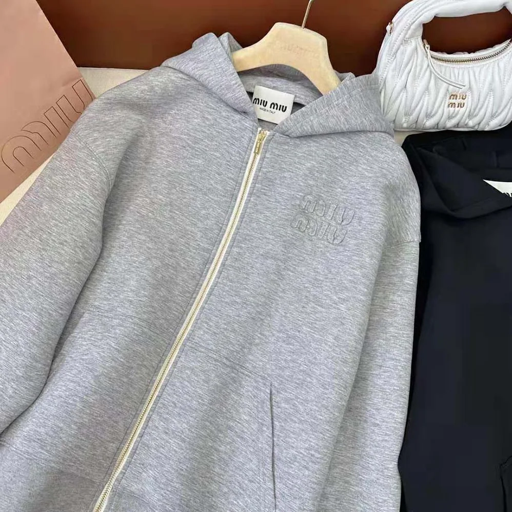 Miu Miu Embroidered Cotton Fleece Hoodie with Embroidered Logo for Women in Silver Miu Miu Embroidered Cotton Fleece Hoodie with Embroidered Logo for Women in Silver