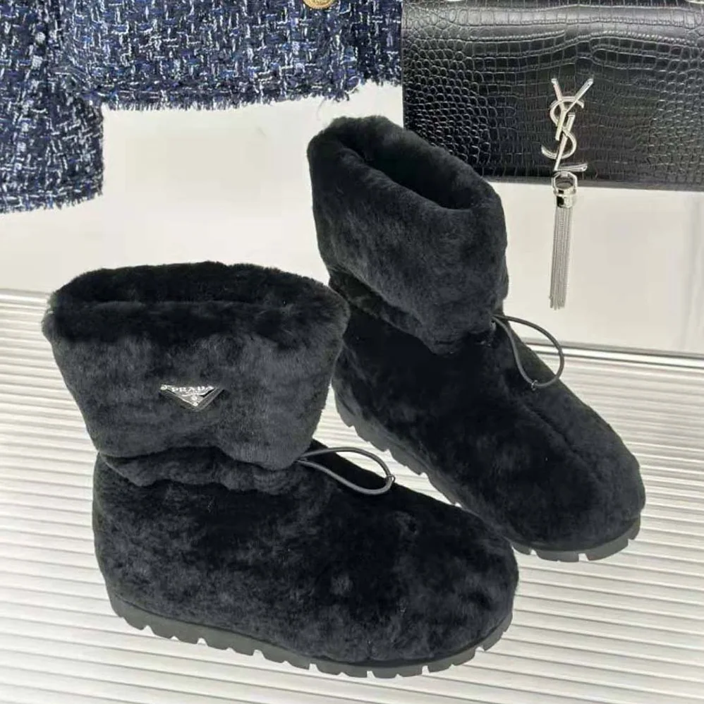 Prada Shearling Booties with Enameled Metal Triangle Logo for Women in Black