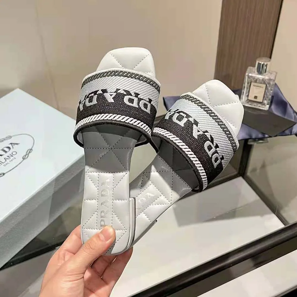 Prada Embroidered Fabric Slides With Embroidered Lettering Logo for Women in White Prada Embroidered Fabric Slides With Embroidered Lettering Logo for Women in White