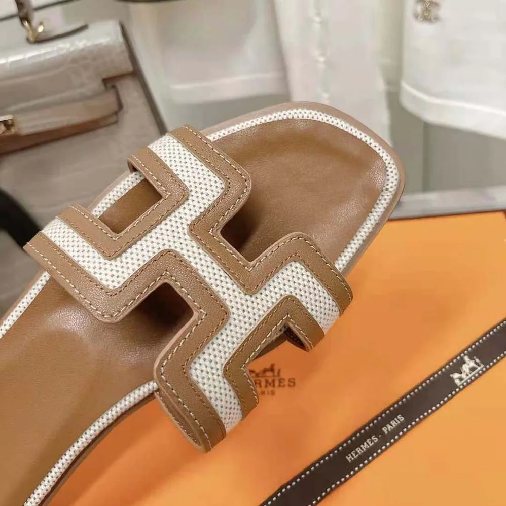 Hermes Oran Sandal in Calfskin and H Canvas with Iconic H Cut for Women in Out Hermes Oran Sandal in Calfskin and H Canvas with Iconic H Cut for Women in Out