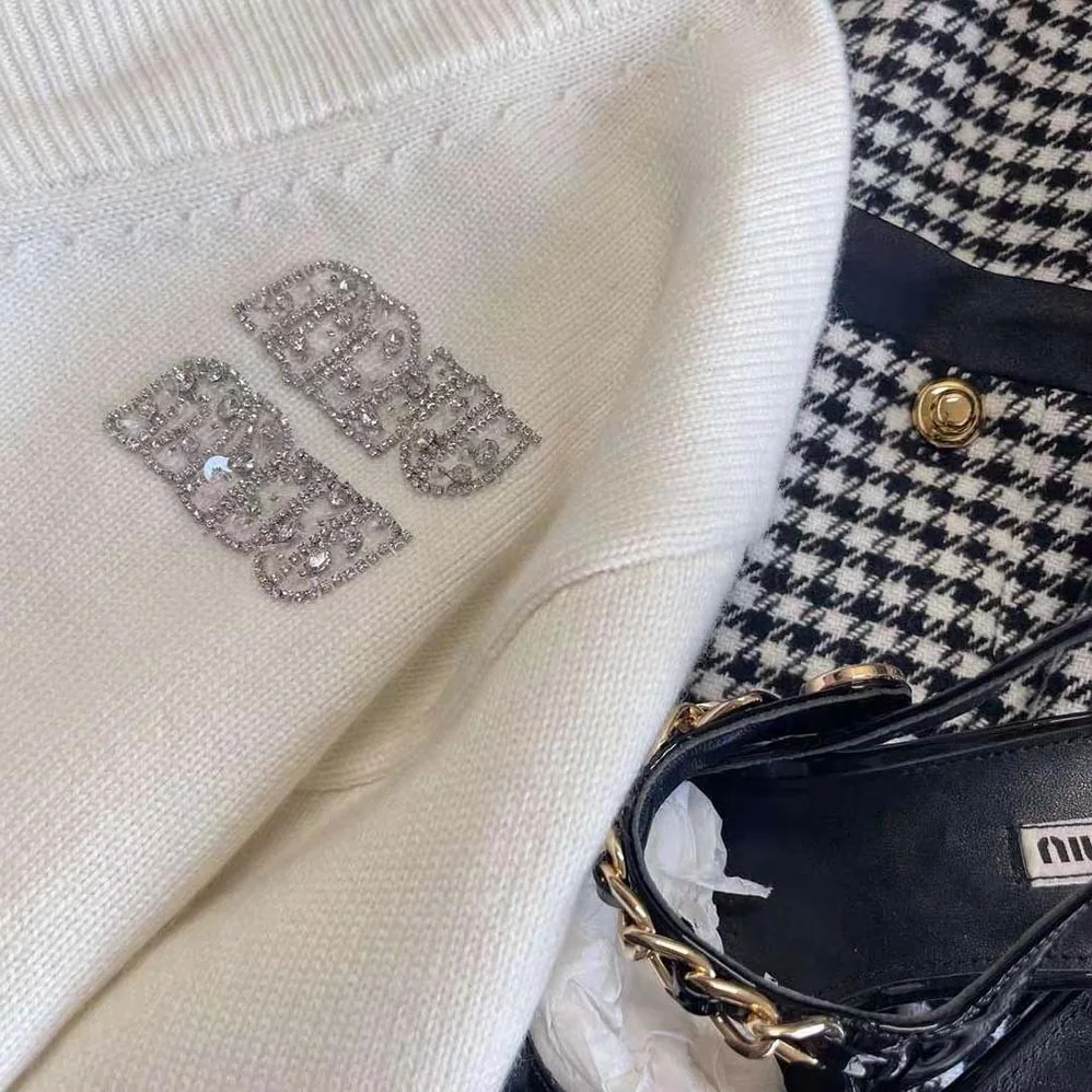 Miu Miu Cashmere Cardigan Features an Embroidered Logo for Women in White Miu Miu Cashmere Cardigan Features an Embroidered Logo for Women in White