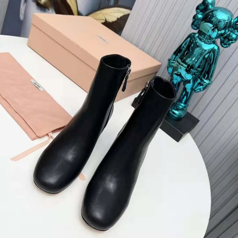 Miu Miu Leather Booties with Metal Lettering Logo for Women in Black