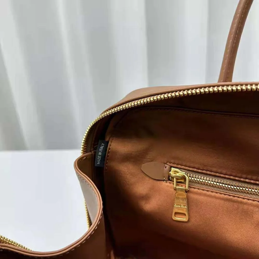 Miu Miu Leather Top-handle Bag with Embossed Lettering Logo for Women in Brown Miu Miu Leather Top-handle Bag with Embossed Lettering Logo for Women in Brown