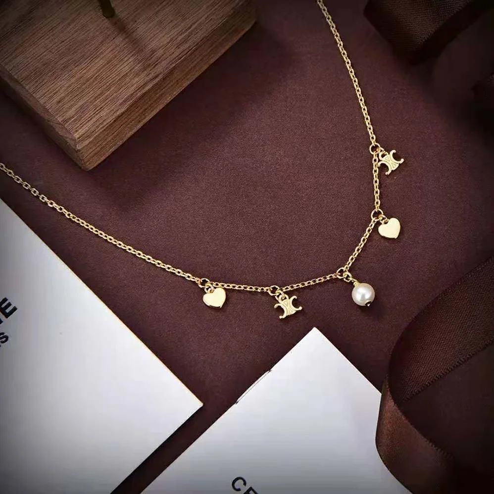 Celine Cœur Celine Charms Necklace in Brass with Gold Finish and Resin Pearl for Women Celine Cœur Celine Charms Necklace in Brass with Gold Finish and Resin Pearl for Women
