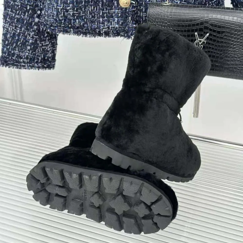 Prada Shearling Booties with Enameled Metal Triangle Logo for Women in Black
