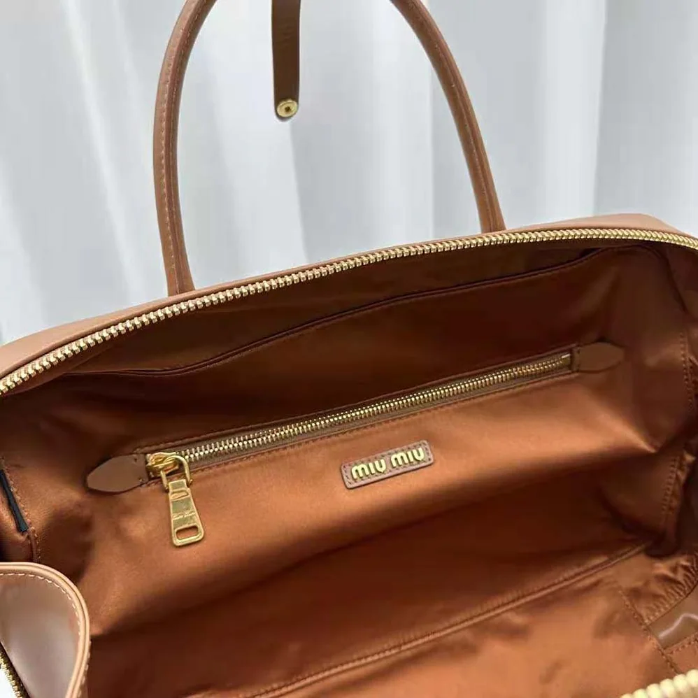 Miu Miu Leather Top-handle Bag with Embossed Lettering Logo for Women in Brown Miu Miu Leather Top-handle Bag with Embossed Lettering Logo for Women in Brown