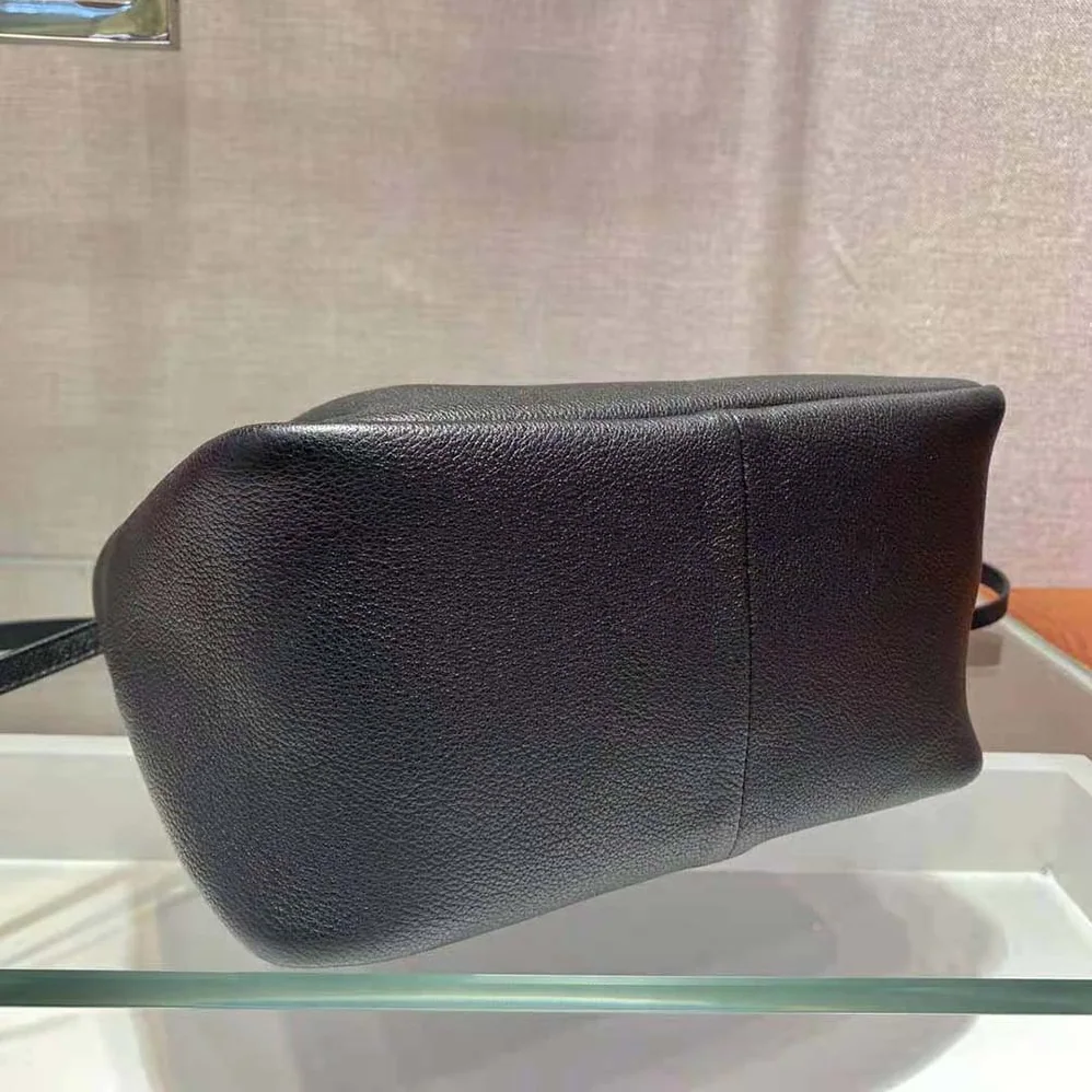 Prada Small leather Handbag with the Prada Metal Lettering Logo Illuminating Its Center for Women Prada Small leather Handbag with the Prada Metal Lettering Logo Illuminating Its Center for Women
