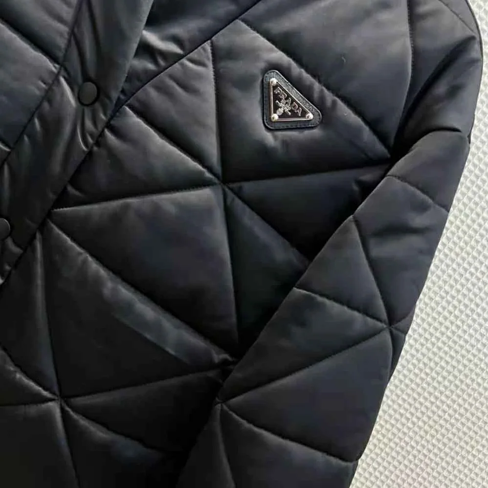 Prada Emblematic Triangle Quilted Re-Nylon Jacket for Women in Black Prada Emblematic Triangle Quilted Re-Nylon Jacket for Women in Black
