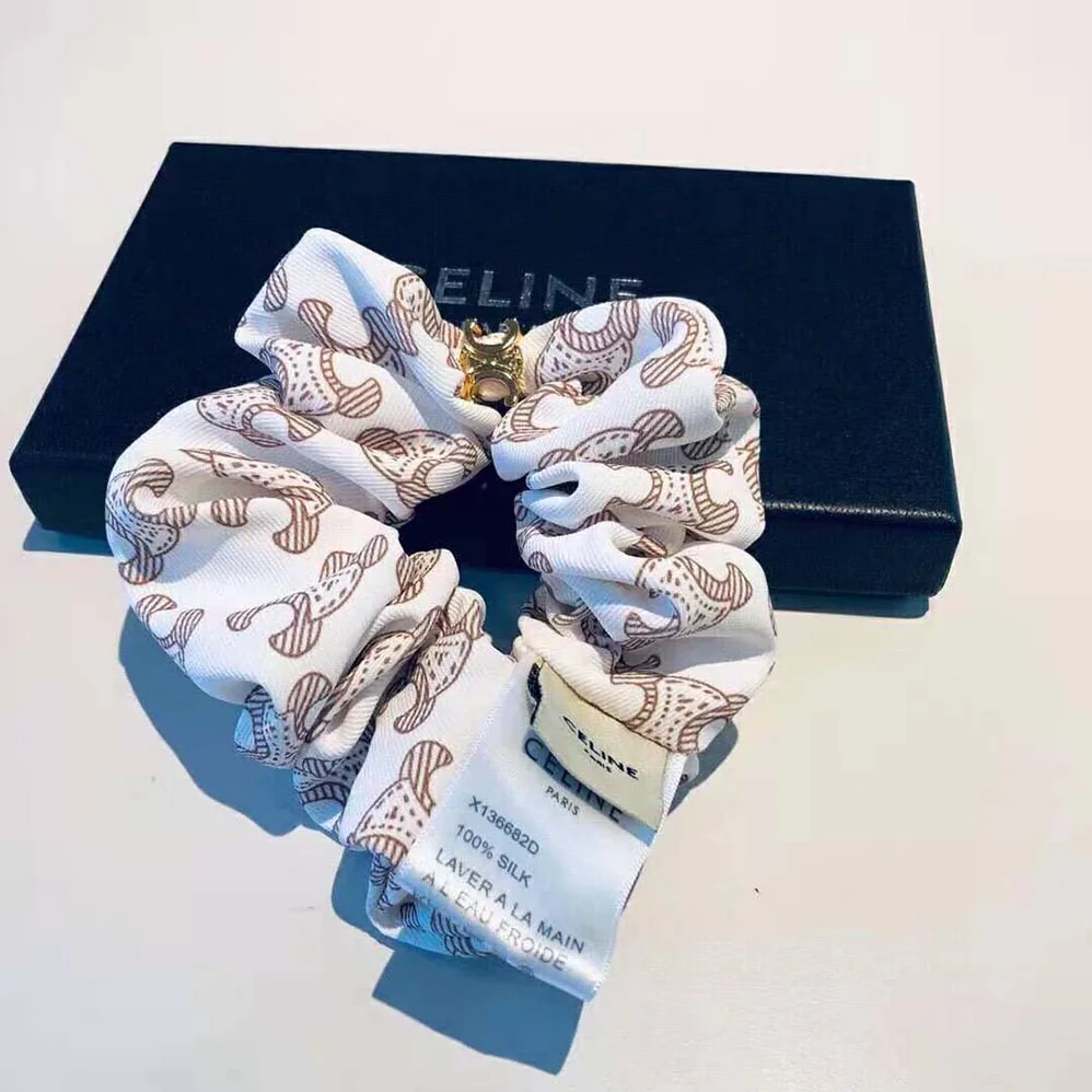 Celine Scrunchy Celine Triomphe Monogram Bracelet in Brass with Gold Finish and White Silk for Women Celine Scrunchy Celine Triomphe Monogram Bracelet in Brass with Gold Finish and White Silk for Women