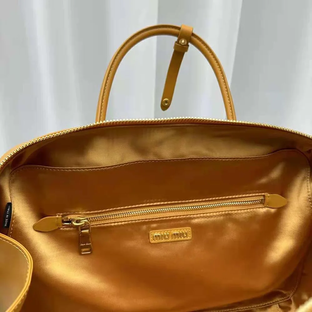 Miu Miu Leather Top-handle Bag with Embossed Lettering Logo for Women in Orange Miu Miu Leather Top-handle Bag with Embossed Lettering Logo for Women in Orange
