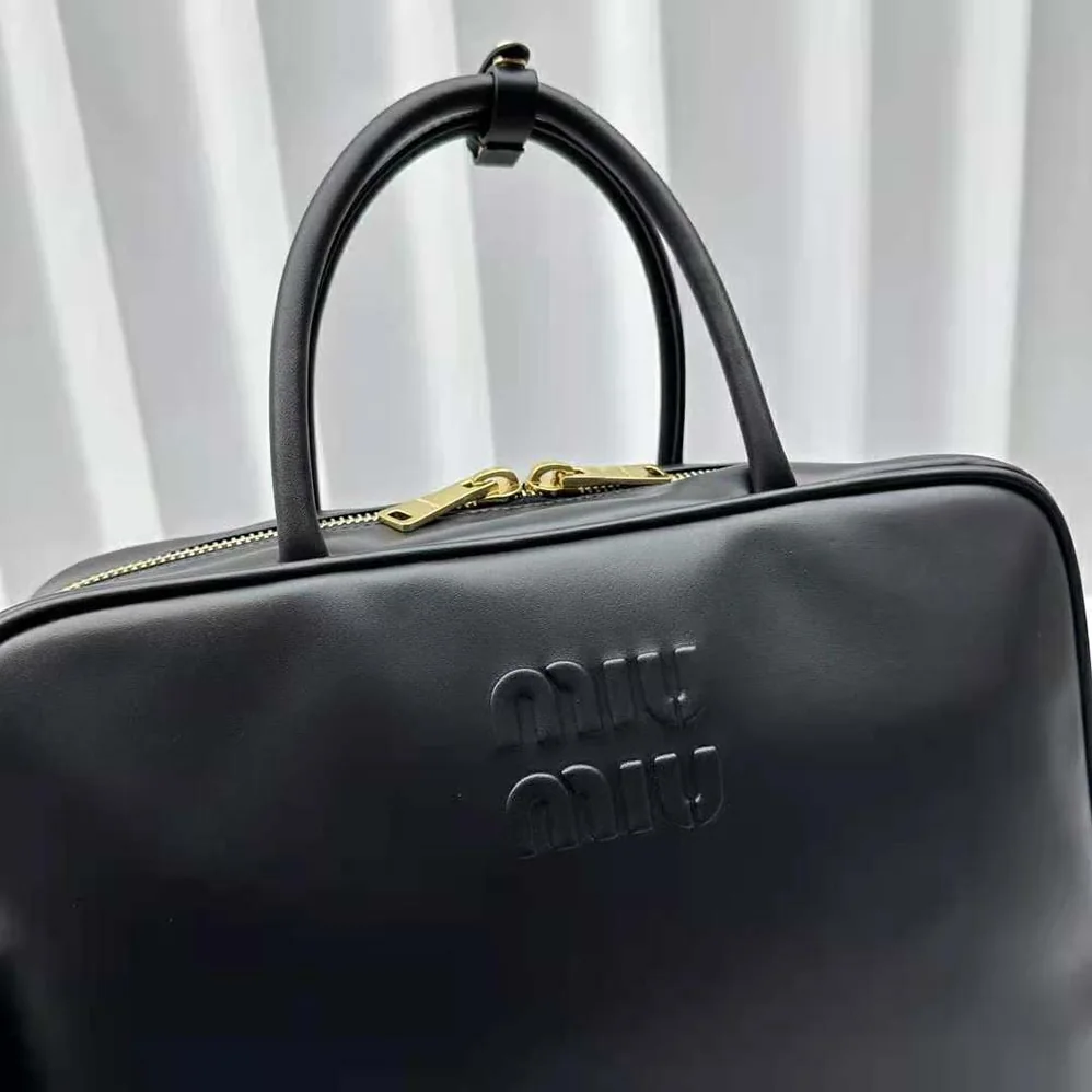 Miu Miu Leather Top-handle Bag with Embossed Lettering Logo for Women in Black Miu Miu Leather Top-handle Bag with Embossed Lettering Logo for Women in Black