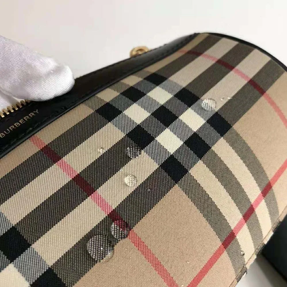 Burberry The Icon Stripe E-canvas and Leather Barrel Bag for Women in Brown Burberry The Icon Stripe E-canvas and Leather Barrel Bag for Women in Brown