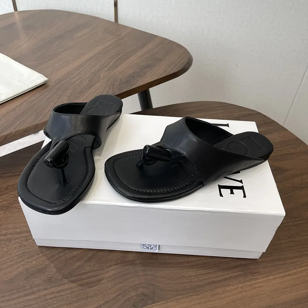 Loewe Toggle Flat Sandal in Shiny Smoot Calfskin for Women in Black Loewe Toggle Flat Sandal in Shiny Smoot Calfskin for Women in Black