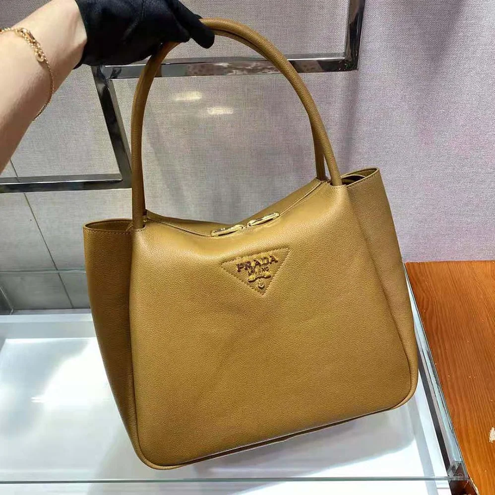 Prada Medium Leather handbag with the Prada Metal Lettering Logo Illuminating Its Center for Women