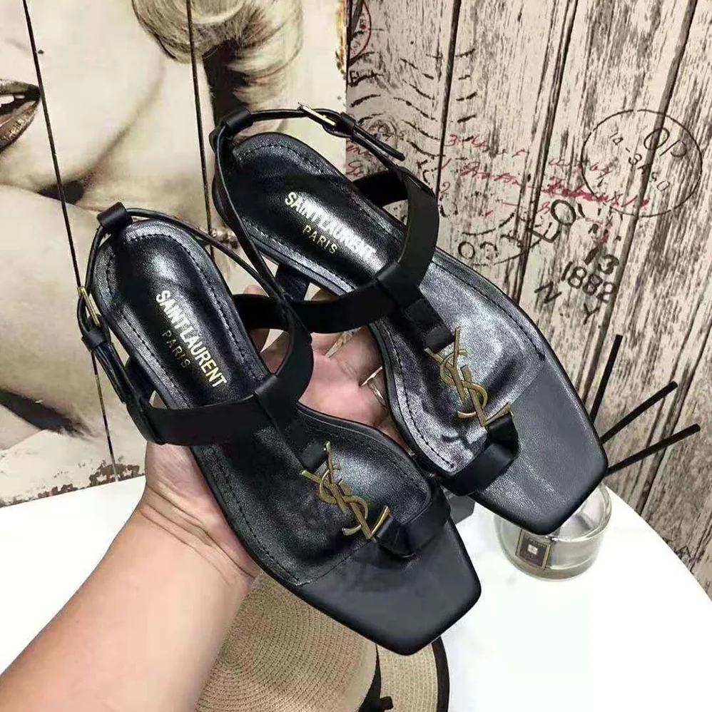 Saint Laurent YSL Cassandra Flat Sandals in Smooth Leather with Gold-tone Monogram for Women in Black