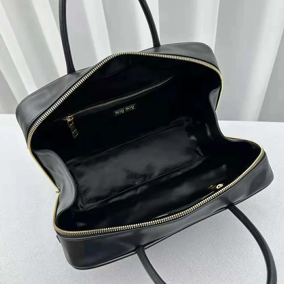 Miu Miu Leather Top-handle Bag with Embossed Lettering Logo for Women in Black Miu Miu Leather Top-handle Bag with Embossed Lettering Logo for Women in Black