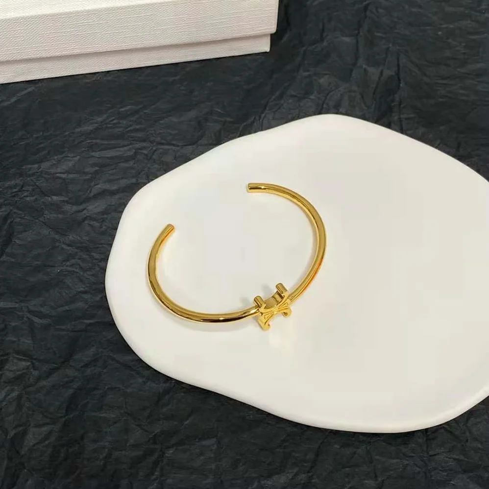 Celine Triomphe Asymmetric Cuff in Brass with Gold Finish for Women Celine Triomphe Asymmetric Cuff in Brass with Gold Finish for Women