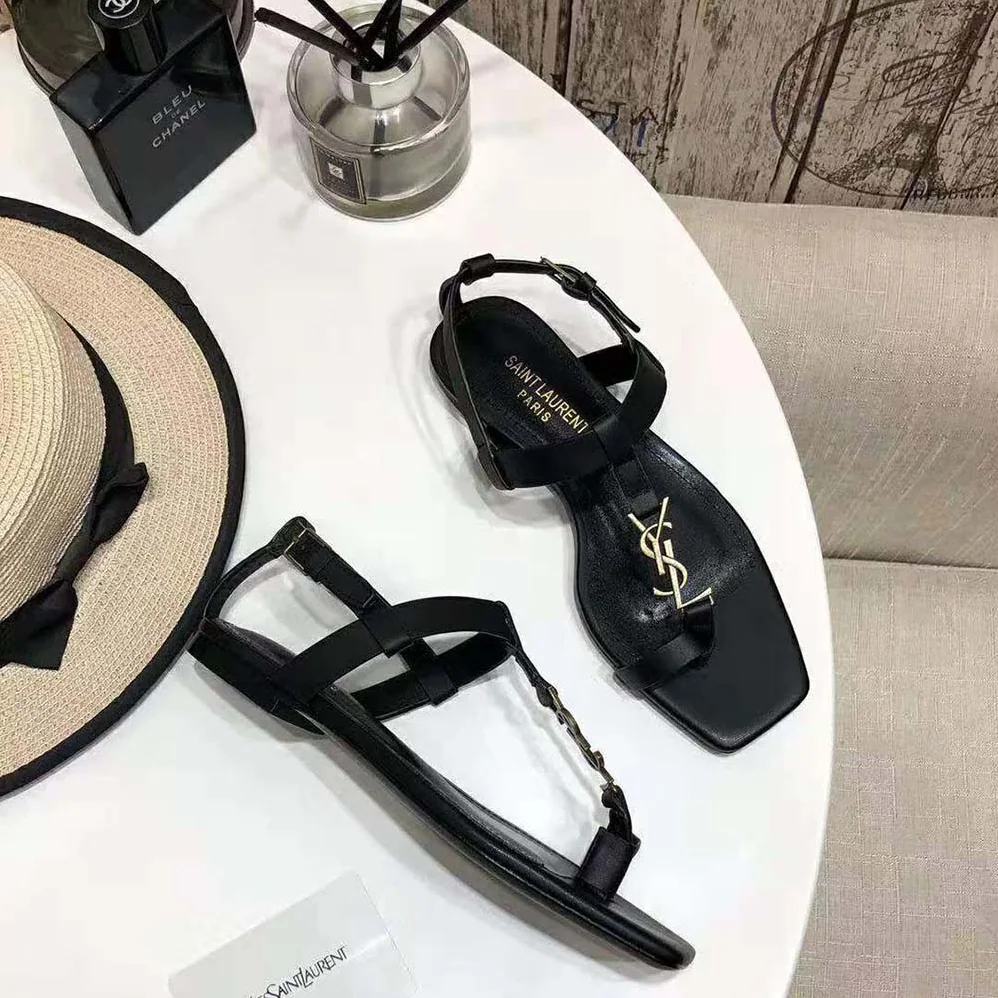Saint Laurent YSL Cassandra Flat Sandals in Smooth Leather with Gold-tone Monogram for Women in Black