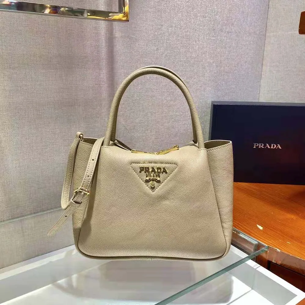 Prada Small leather Handbag with the Prada Metal Lettering Logo Illuminating Its Center for Women in Sandy