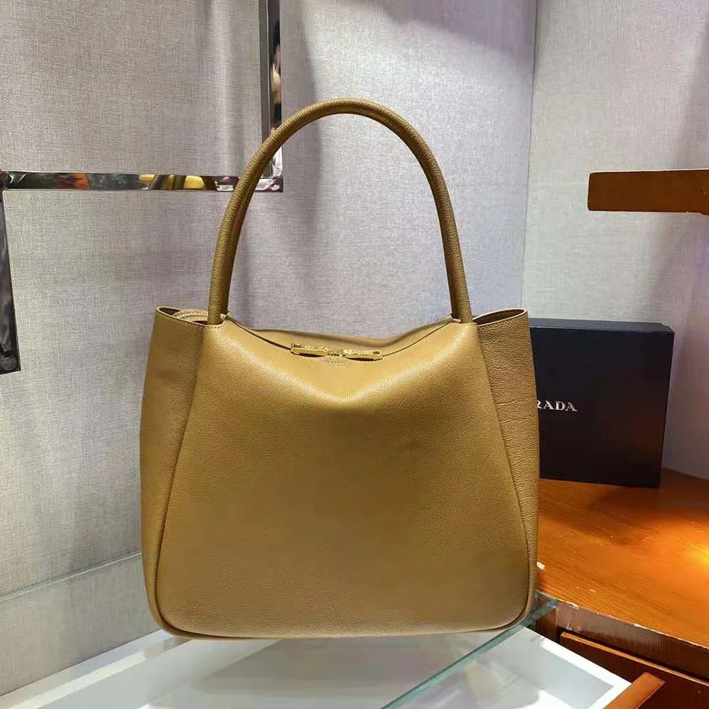 Prada Medium Leather handbag with the Prada Metal Lettering Logo Illuminating Its Center for Women