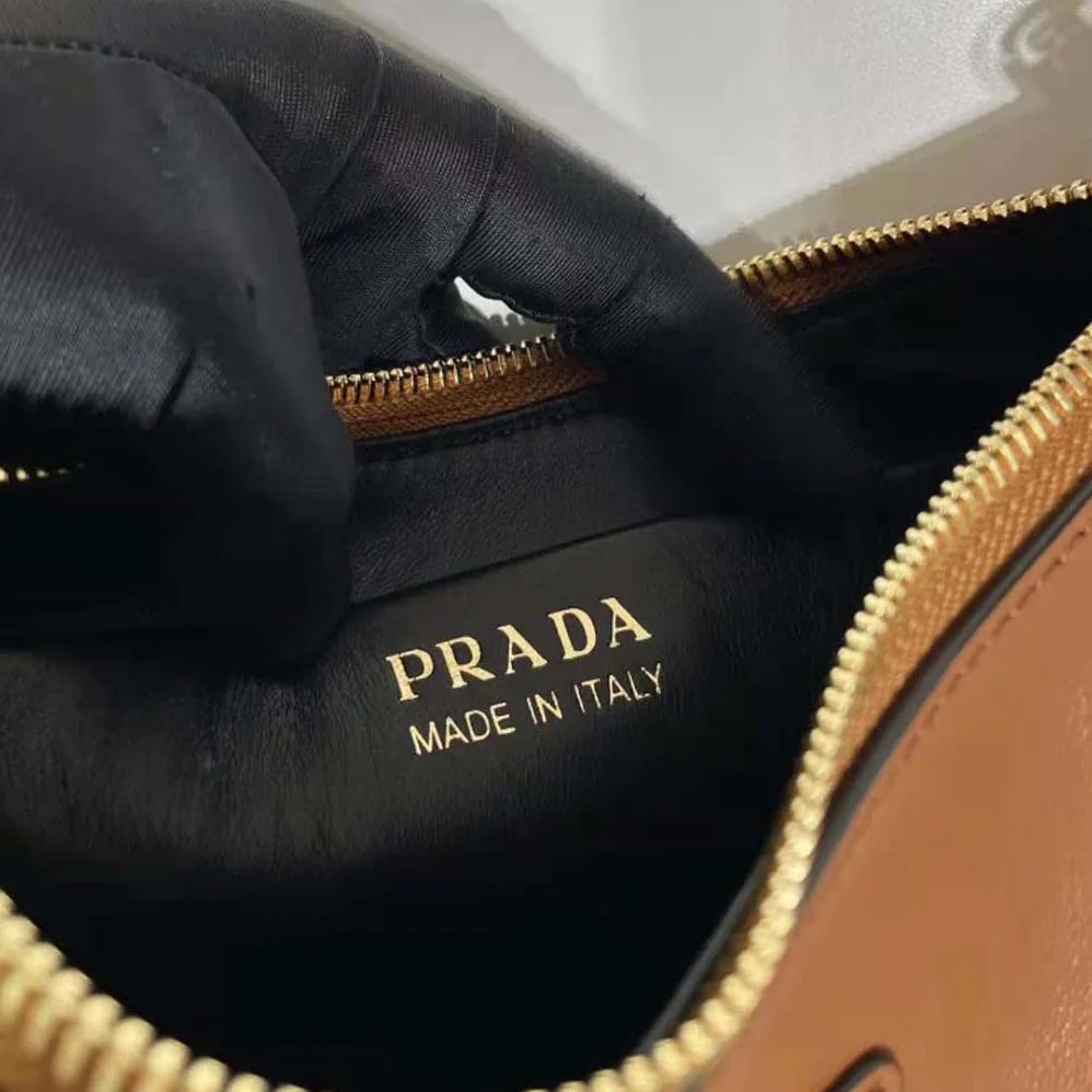 Prada Leather Shoulder Bag with Enameled Metal Triangle Logo for Women in Brown Prada Leather Shoulder Bag with Enameled Metal Triangle Logo for Women in Brown
