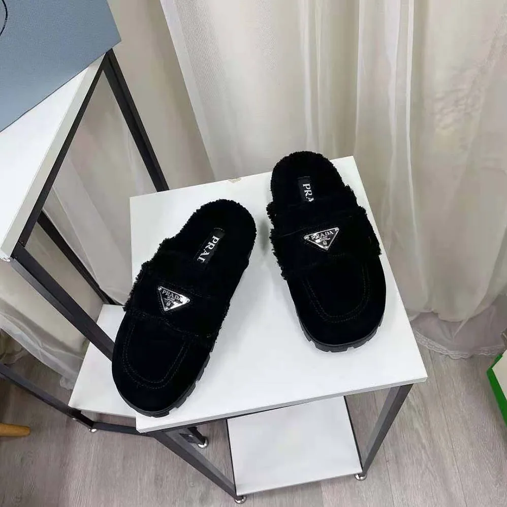 Prada Shearling Slippers Enameled Metal Triangle Logo for Women in Black