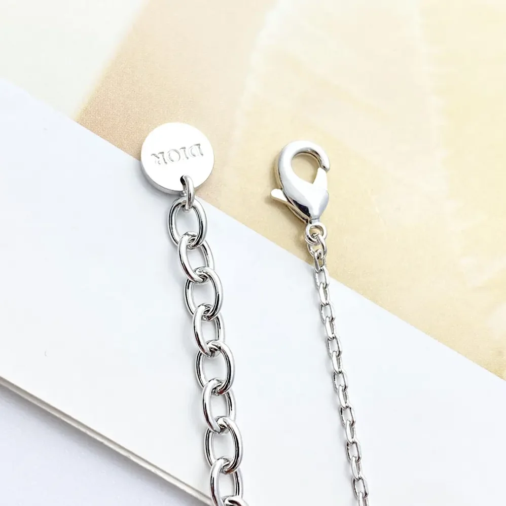 Dior Petit CD Lucky Charms Bracelet Silver-Finish Metal with White Resin Pearl and Silver for Women in Tone Crystals Dior Petit CD Lucky Charms Bracelet Silver-Finish Metal with White Resin Pearl and Silver for Women in Tone Crystals