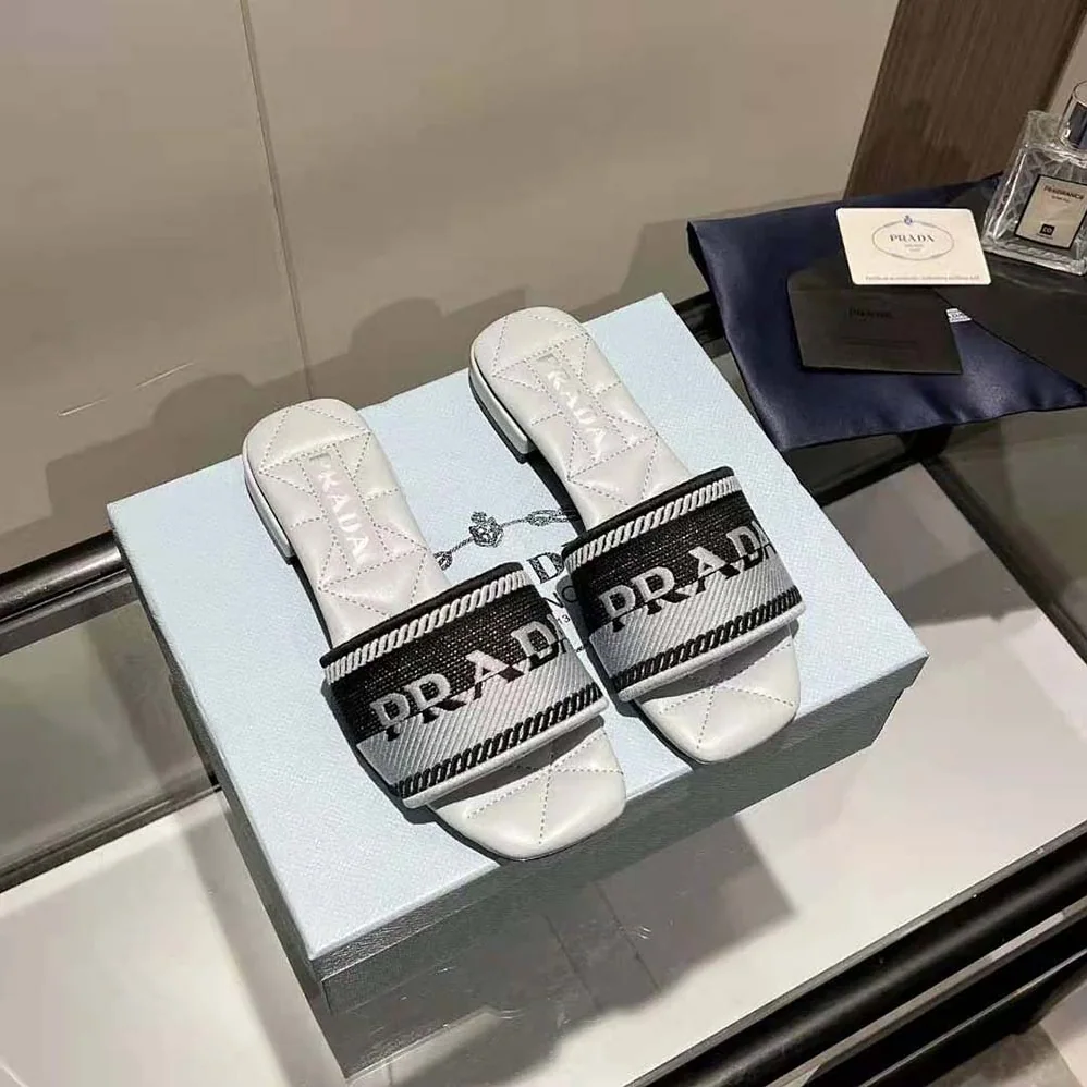Prada Embroidered Fabric Slides With Embroidered Lettering Logo for Women in White Prada Embroidered Fabric Slides With Embroidered Lettering Logo for Women in White