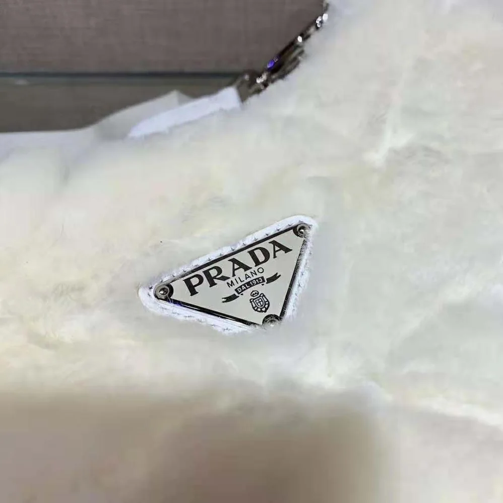 Prada A Patchwork-style Triangle Motif Characterizes Shearling Shoulder Bag for Women Prada A Patchwork-style Triangle Motif Characterizes Shearling Shoulder Bag for Women