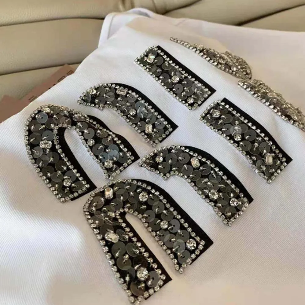 Miu Miu Embroidered Cotton T-shirt with Embroidered Logo for Women in White Miu Miu Embroidered Cotton T-shirt with Embroidered Logo for Women in White