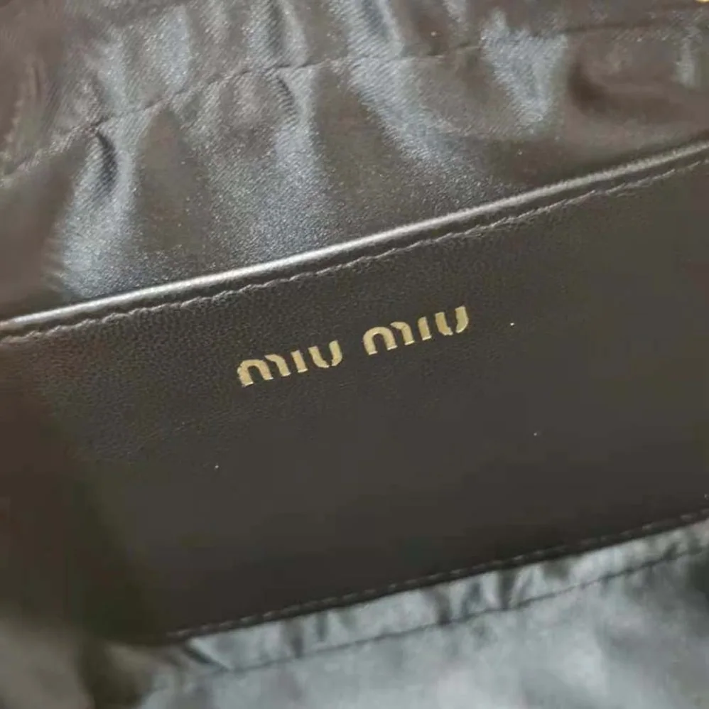 Miu Miu Matelassé Nappa Leather Top-Handle Mini-Bag for Women in Black Miu Miu Matelassé Nappa Leather Top-Handle Mini-Bag for Women in Black