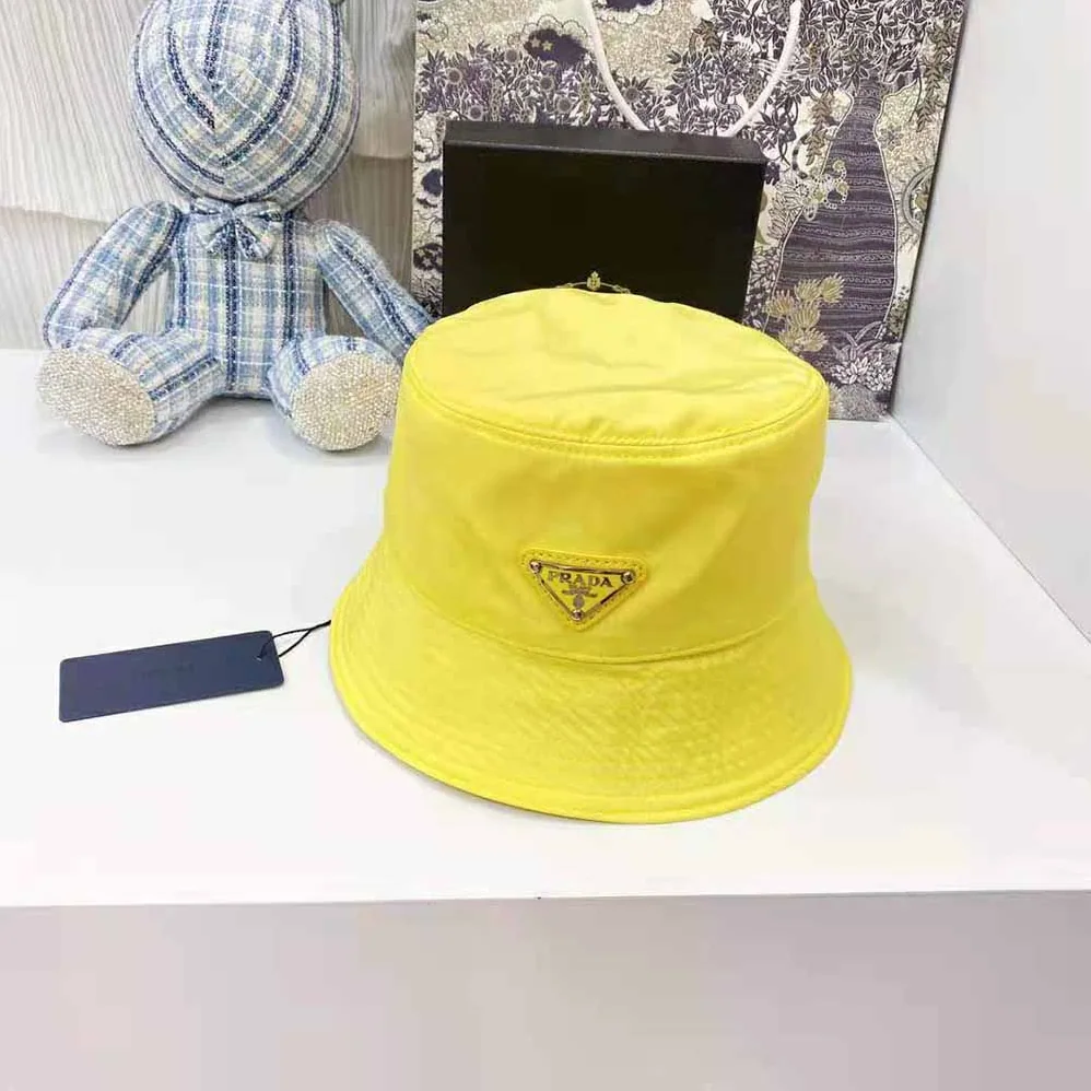 Prada Nylon Bucket Hat Decorated with the Triangle Logo for Women in Yellow