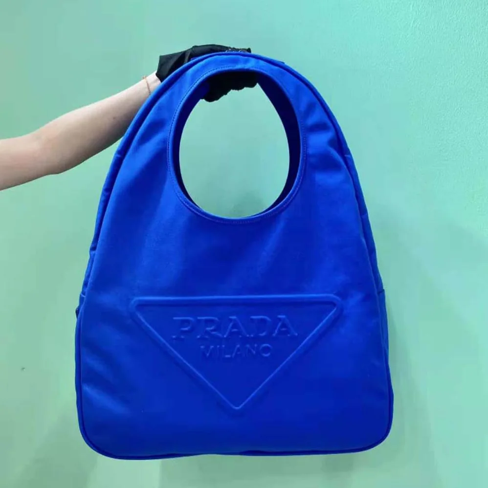 Prada Canvas Hobo Bag with Embossed Logo on the Front for Men in Blue Prada Canvas Hobo Bag with Embossed Logo on the Front for Men in Blue