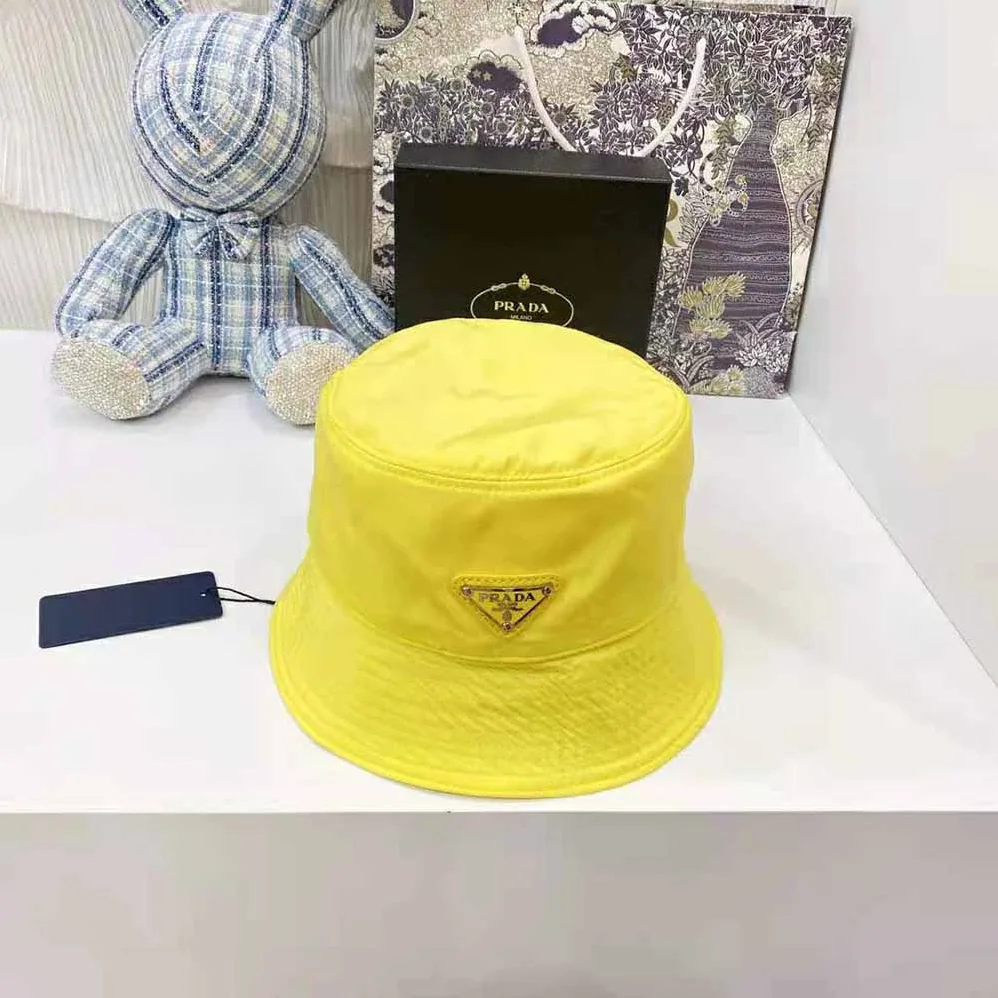 Prada Nylon Bucket Hat Decorated with the Triangle Logo for Women in Yellow