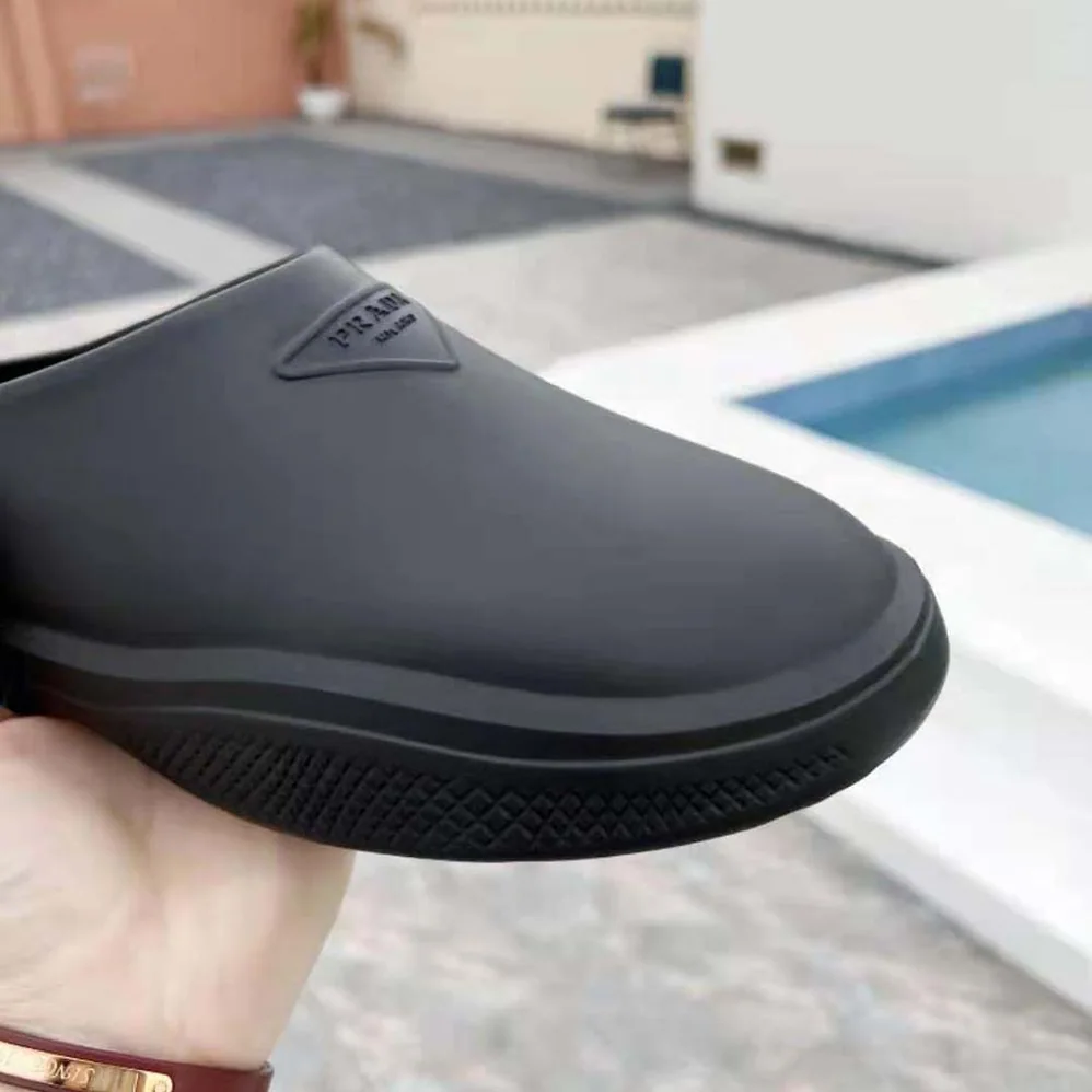 Prada Foam Rubber Mules With Embossed Rubber Triangle Logo for Women in Black Prada Foam Rubber Mules With Embossed Rubber Triangle Logo for Women in Black