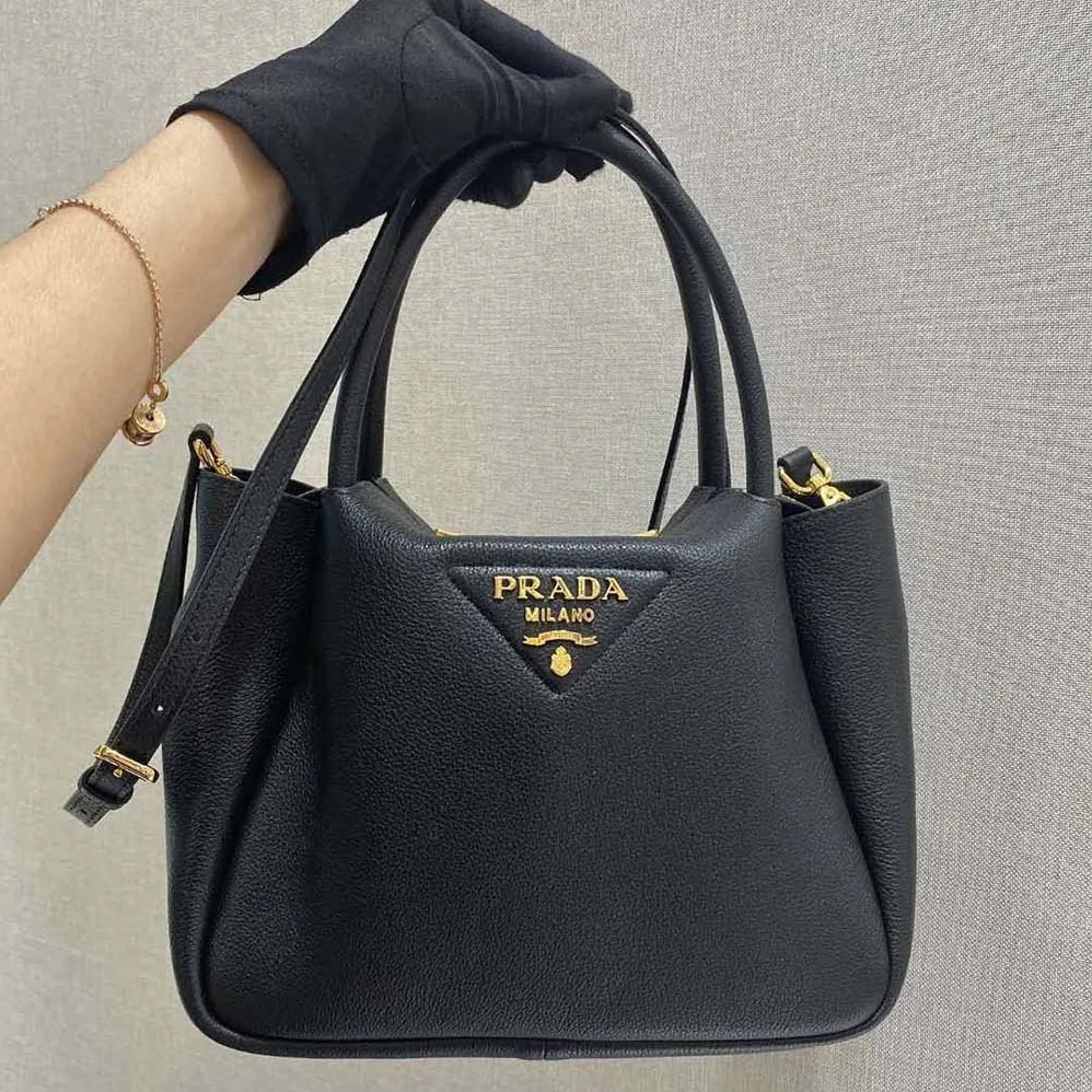 Prada Small leather Handbag with the Prada Metal Lettering Logo Illuminating Its Center for Women Prada Small leather Handbag with the Prada Metal Lettering Logo Illuminating Its Center for Women