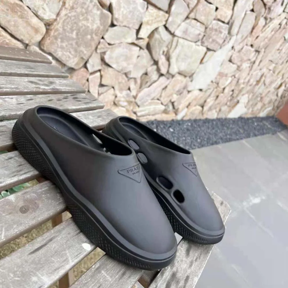 Prada Foam Rubber Mules With Embossed Rubber Triangle Logo for Women in Black Prada Foam Rubber Mules With Embossed Rubber Triangle Logo for Women in Black