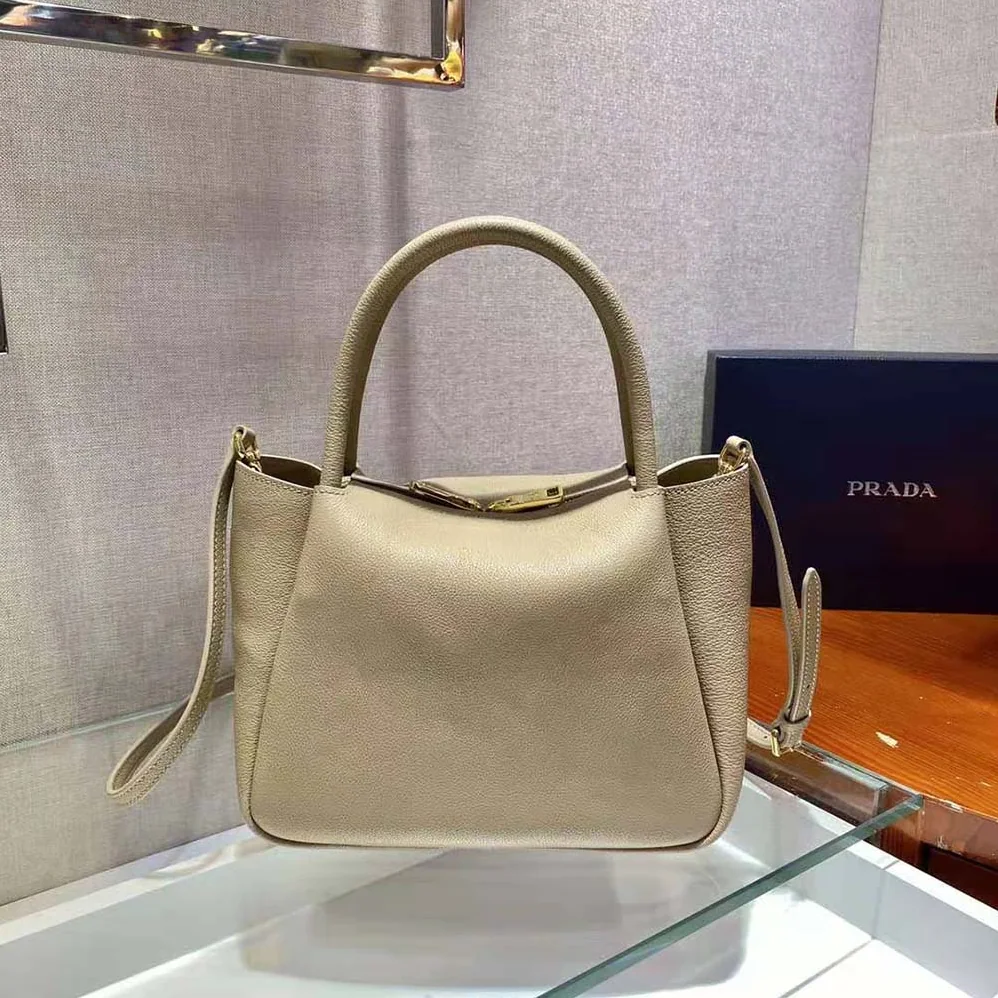 Prada Small leather Handbag with the Prada Metal Lettering Logo Illuminating Its Center for Women in Sandy