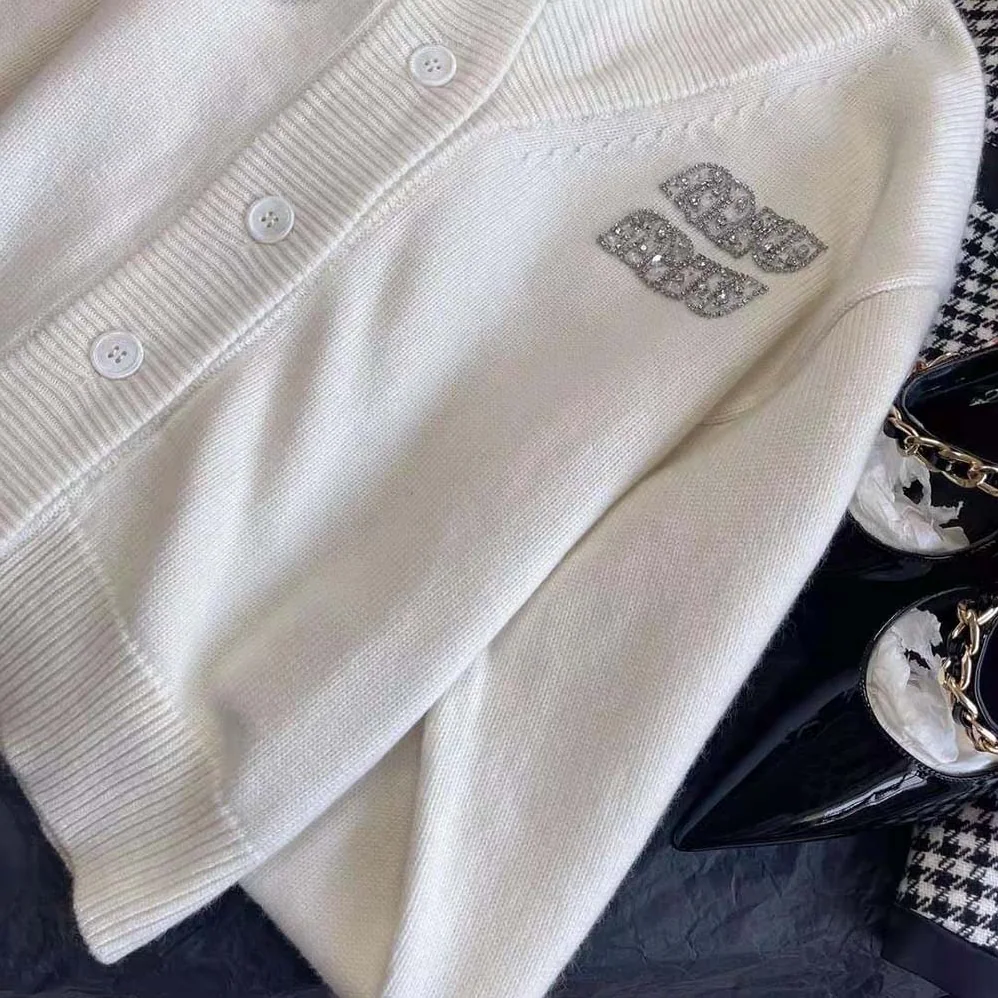 Miu Miu Cashmere Cardigan Features an Embroidered Logo for Women in White Miu Miu Cashmere Cardigan Features an Embroidered Logo for Women in White