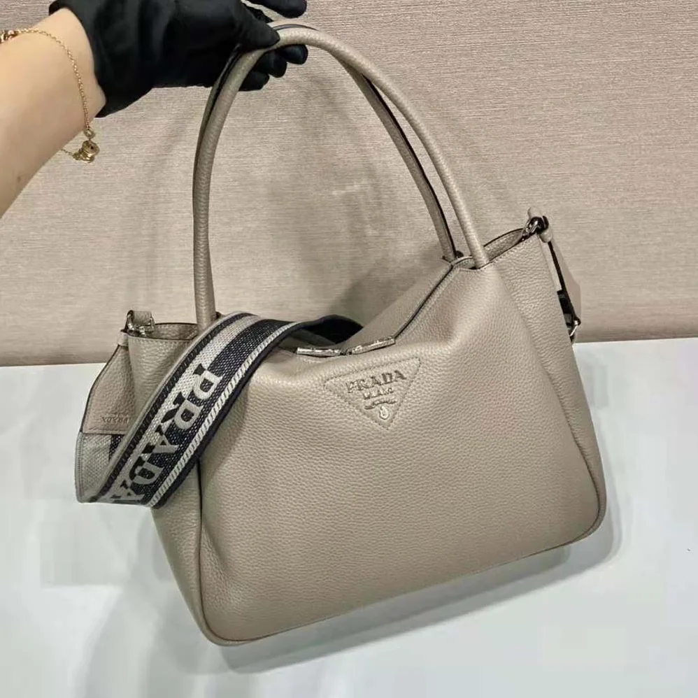 Prada Large Leather Handbag with the Prada Metal Lettering Logo Gleaming at Its Center for Women in Brown Prada Large Leather Handbag with the Prada Metal Lettering Logo Gleaming at Its Center for Women in Brown