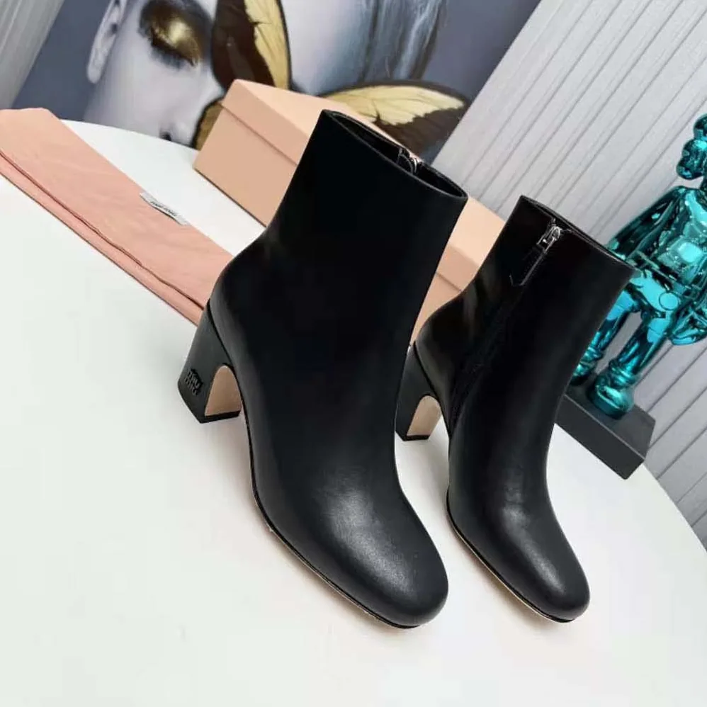 Miu Miu Leather Booties with Metal Lettering Logo for Women in Black