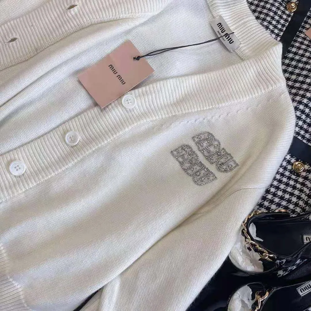 Miu Miu Cashmere Cardigan Features an Embroidered Logo for Women in White Miu Miu Cashmere Cardigan Features an Embroidered Logo for Women in White