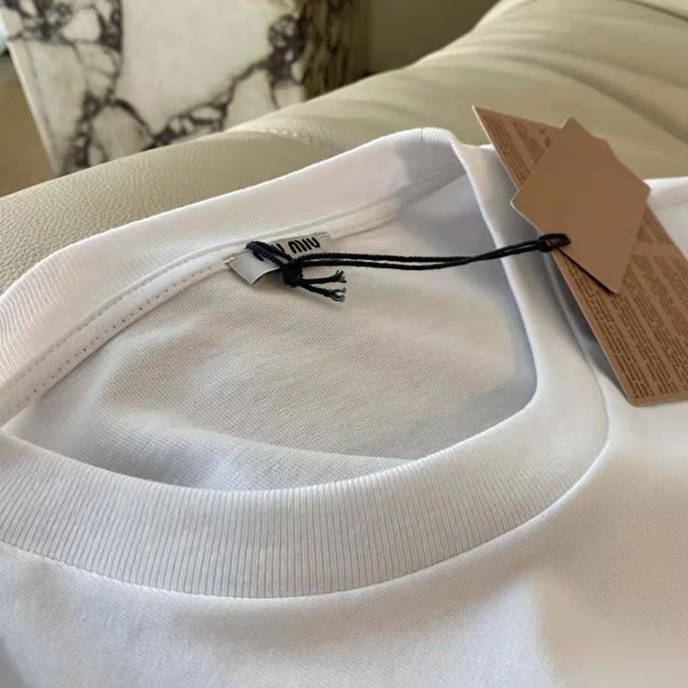 Miu Miu Embroidered Cotton T-shirt with Embroidered Logo for Women in White Miu Miu Embroidered Cotton T-shirt with Embroidered Logo for Women in White