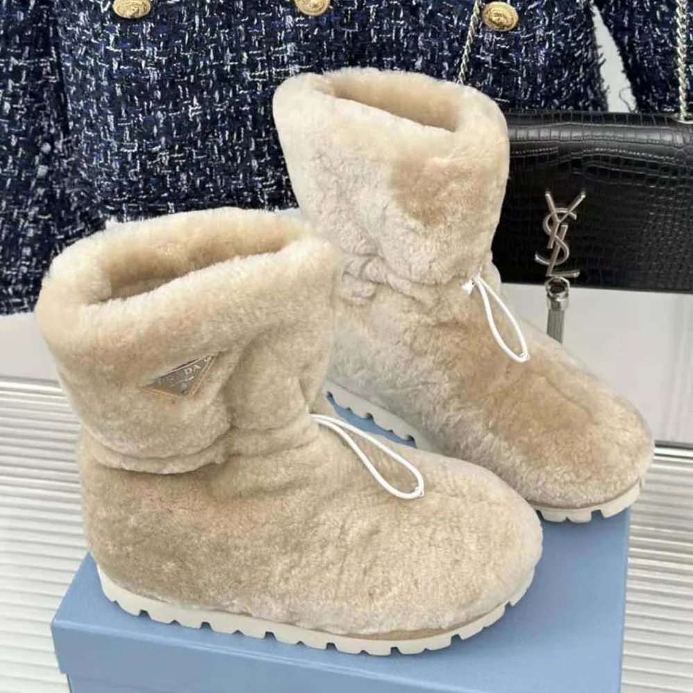 Prada Shearling Booties with Enameled Metal Triangle Logo for Women in Beige