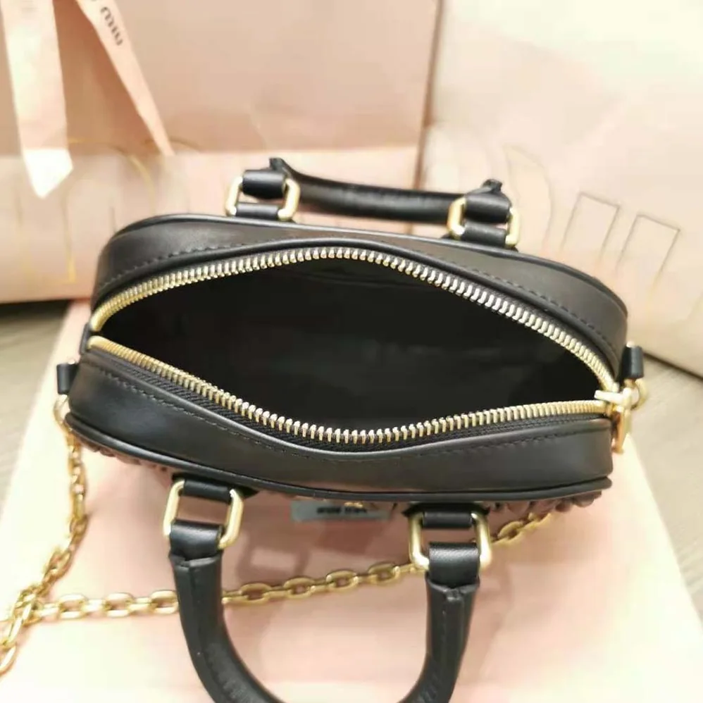Miu Miu Matelassé Nappa Leather Top-Handle Mini-Bag for Women in Black Miu Miu Matelassé Nappa Leather Top-Handle Mini-Bag for Women in Black